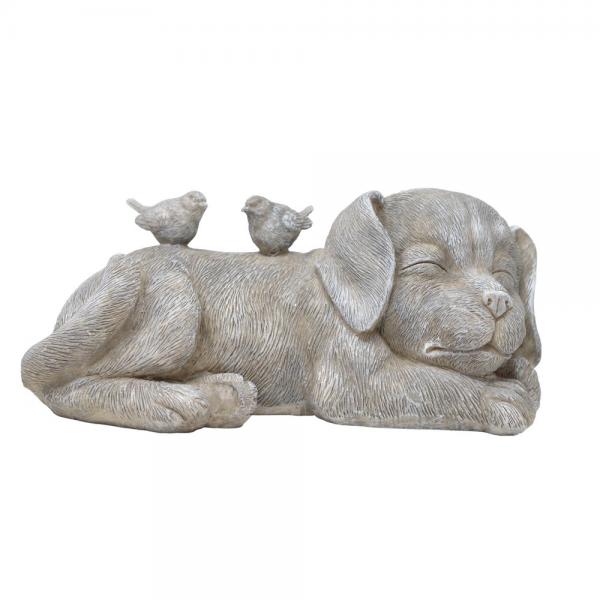 Statue of a resting dog with two birds on its back against a white background
